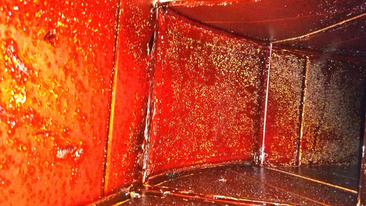 Grease inside commercial kitchen duct before treatment